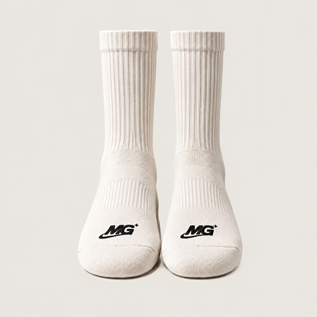 Crew Sock 01 in Vintage White, front view of the pair, with MG branding on top of the toes. Design concept.